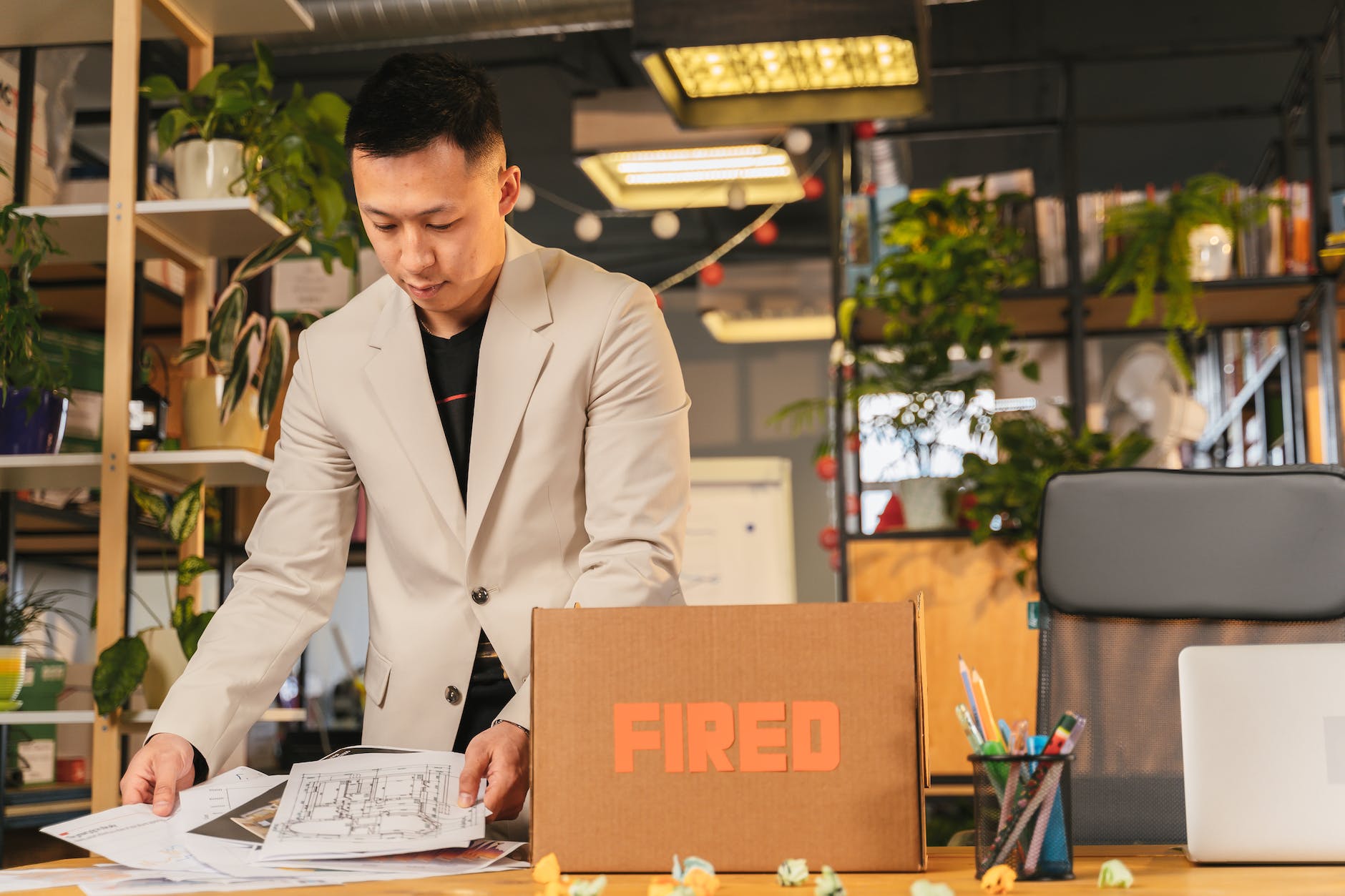 fired employee packing his things at office