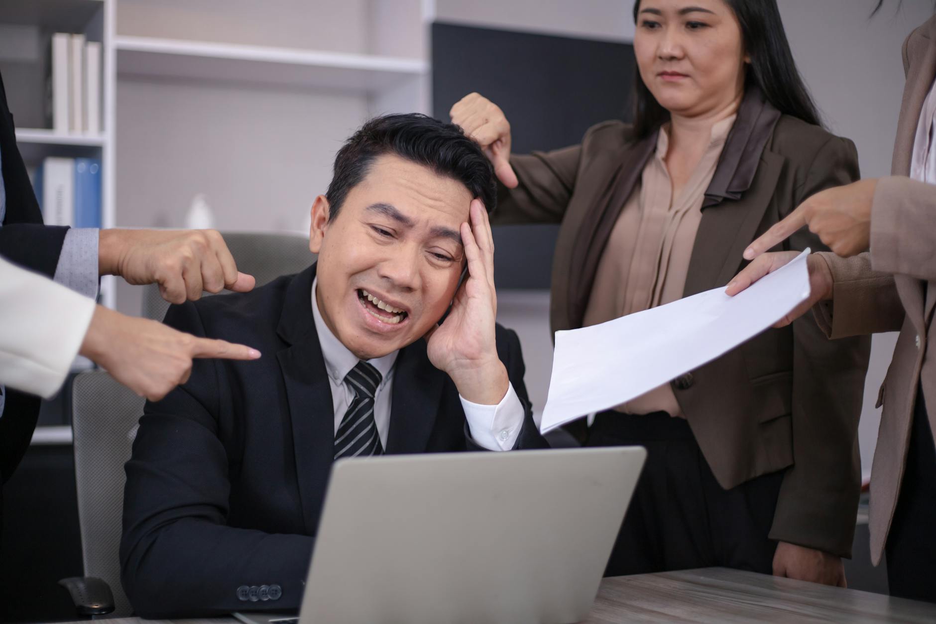 annoyed man looking at his laptop