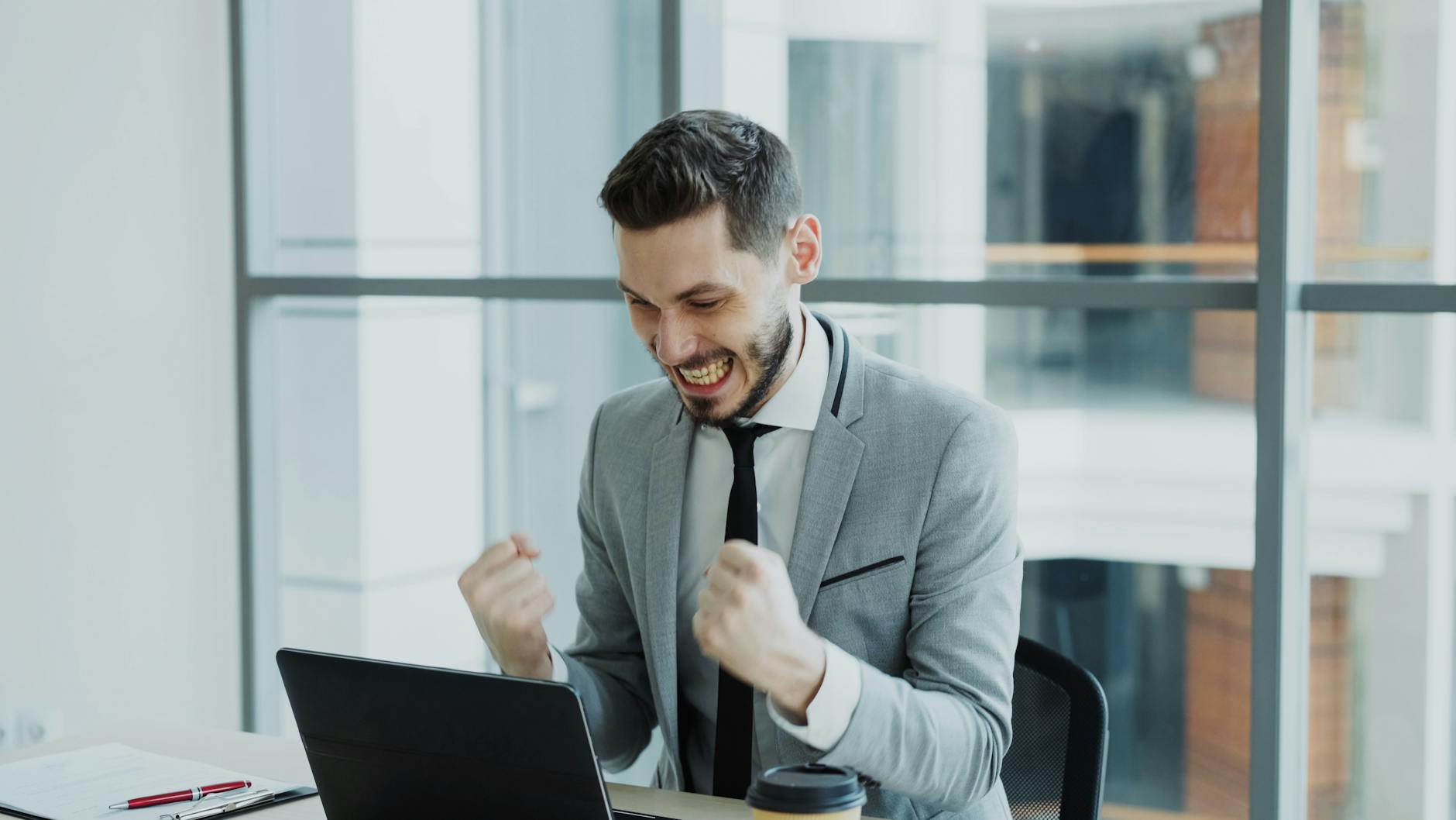 excited businessman celebrating success at work