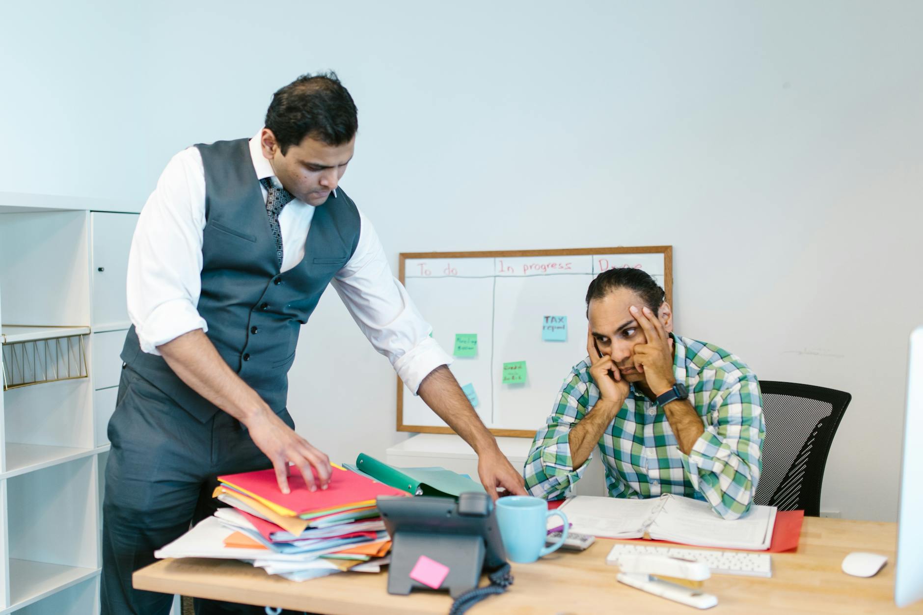 stressed man wearing plaid shirt