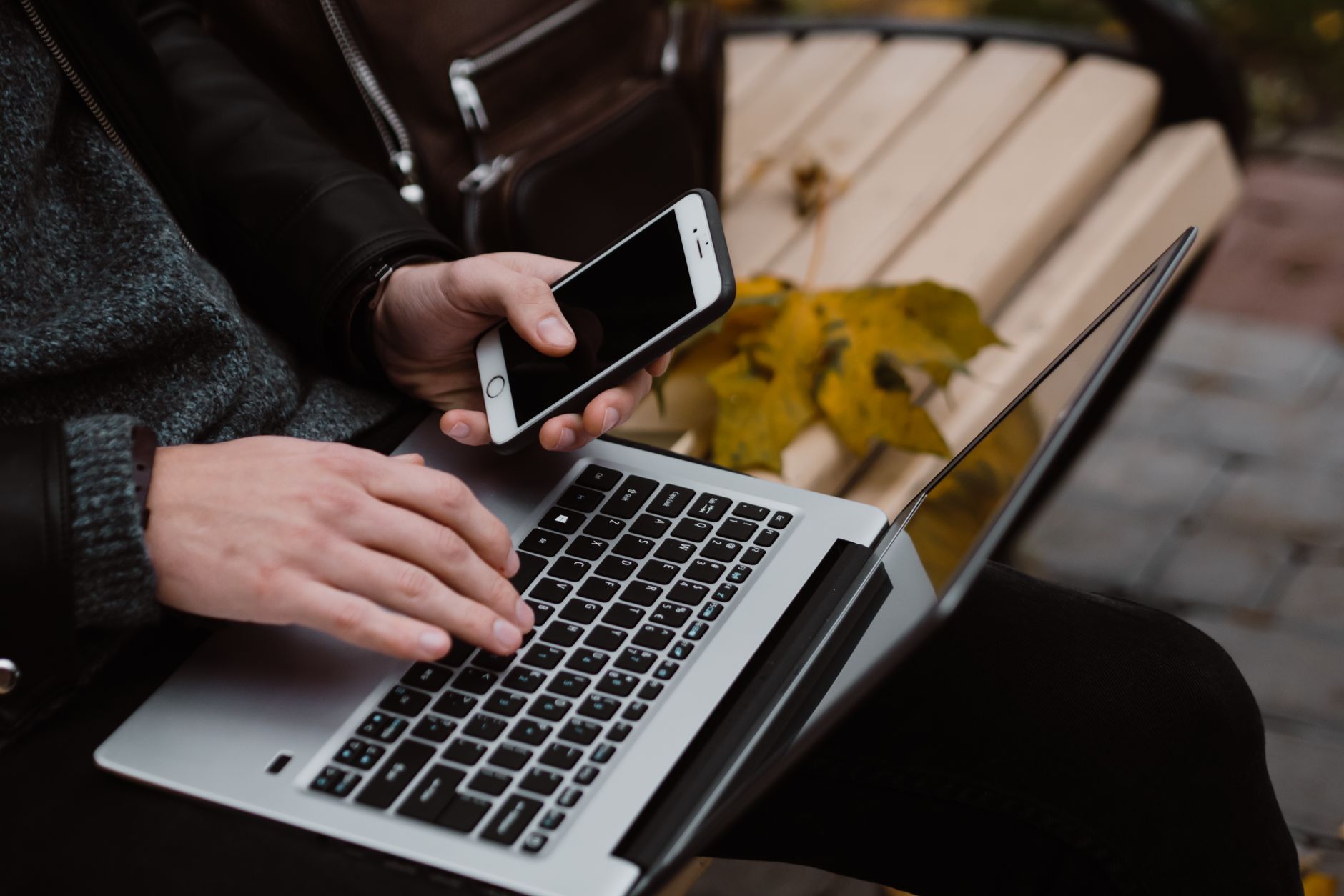 person in black jacket using a laptop